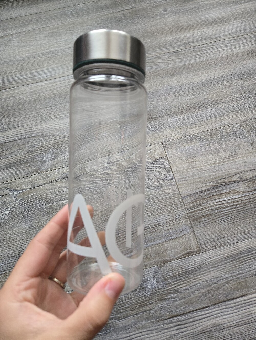 Clear Plastic AG1 Water Bottle with Silver Stainless Cap and White Logo